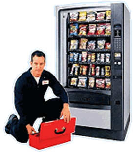 A man is kneeling next to a vending machine with a toolbox.