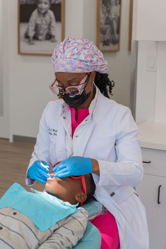 Bright dental clinic with colorful chairs, dental chairs, and tools in a modern treatment room