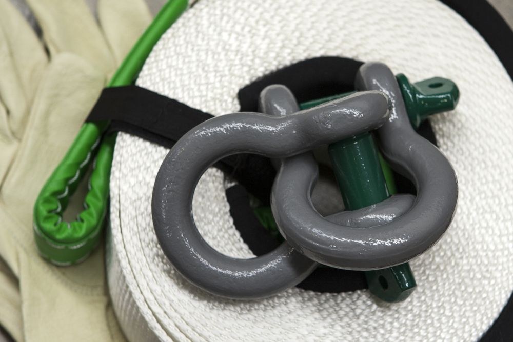 Gray and Green Chain Links Tangled on a White Textured Surface — Air & Lift Gear in Buderim, QLD