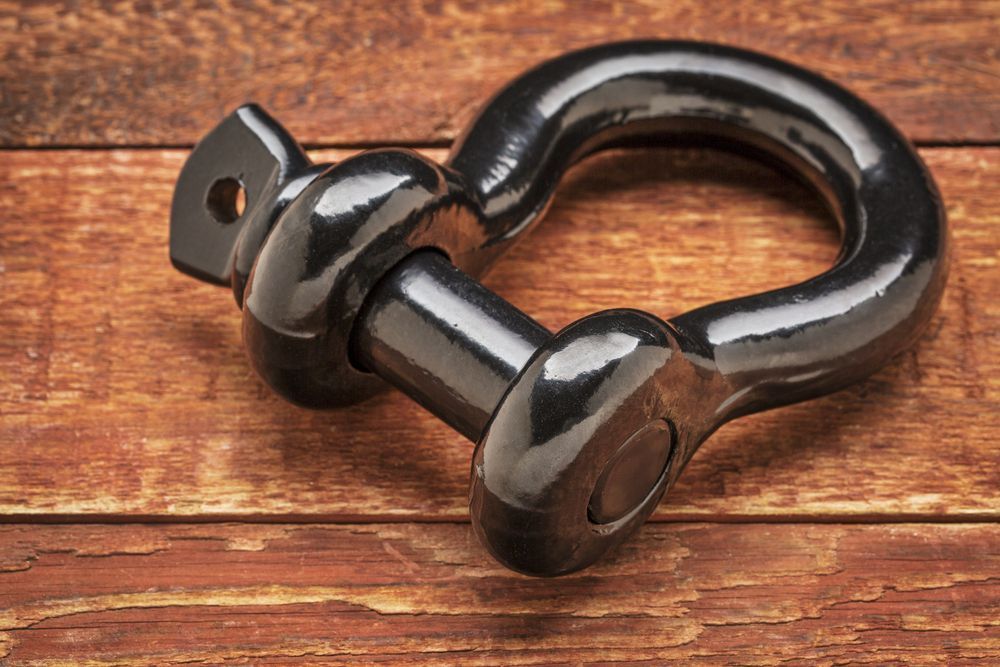 Black Metal Shackle on a Wooden Surface — Air & Lift Gear in Buderim, QLD