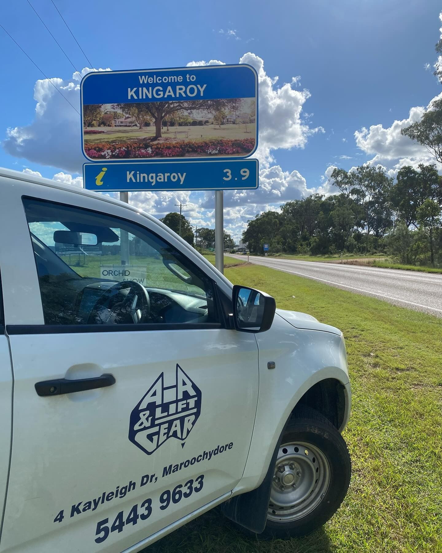 White Roadside Service Vehicle Beside a Blue “Welcome to Kingaroy” Sign — Air & Lift Gear in Buderim, QLD