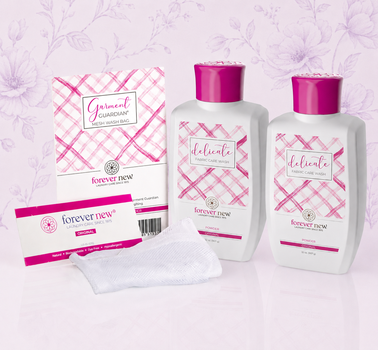Pink-and-white Forever New body lotion and wash bottles with matching boxed soap and towel