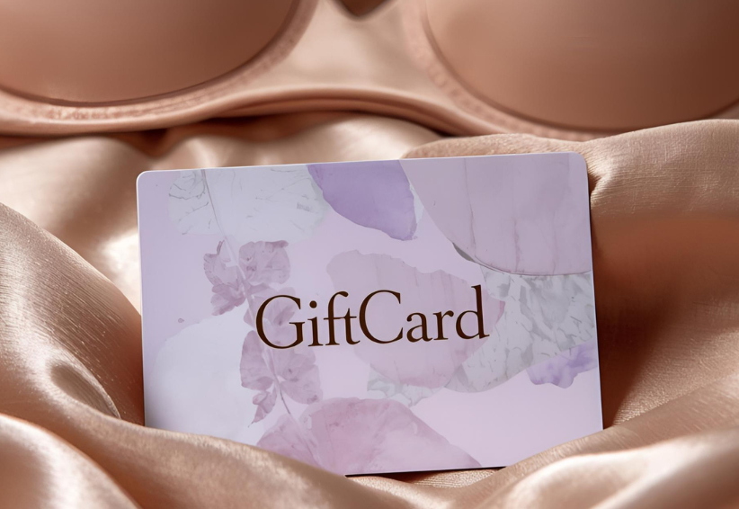Beige bra on satin fabric with a gift card.