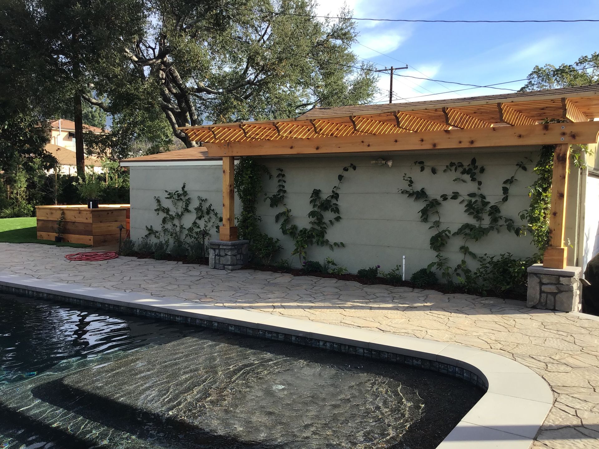 A swimming pool with a pergola over it