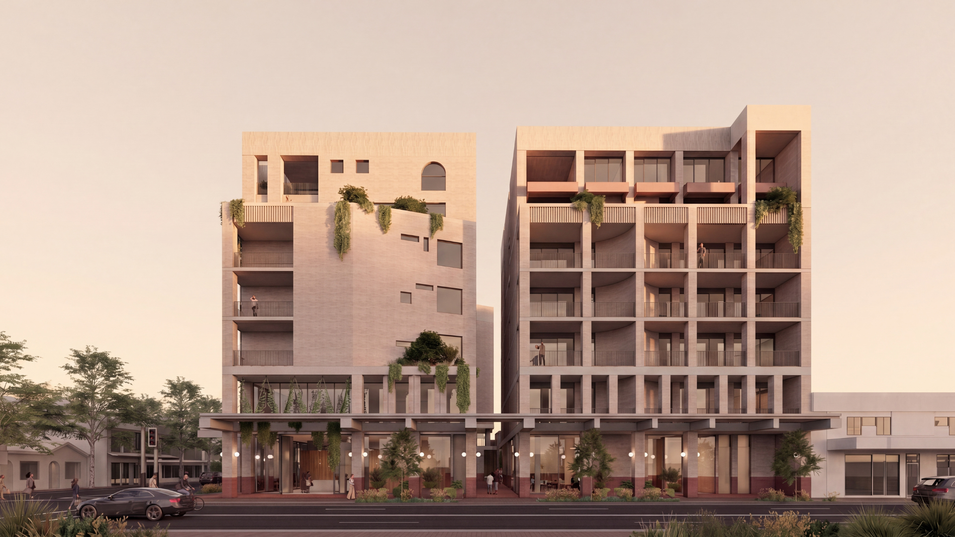Modern mid-rise apartment building with balconies and greenery at street level at sunset