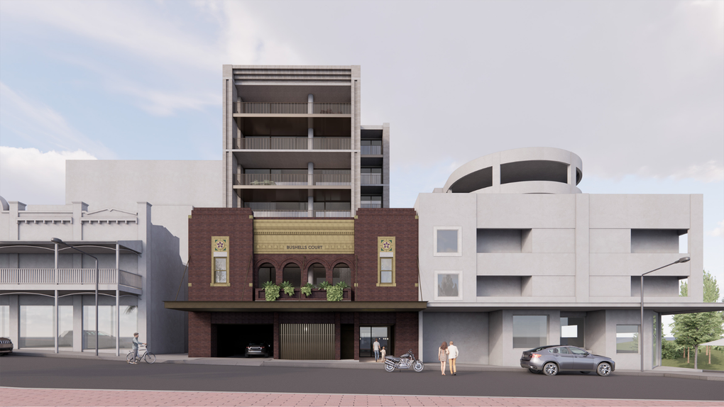 Street view of modern mixed-use buildings with cars parked along the curb