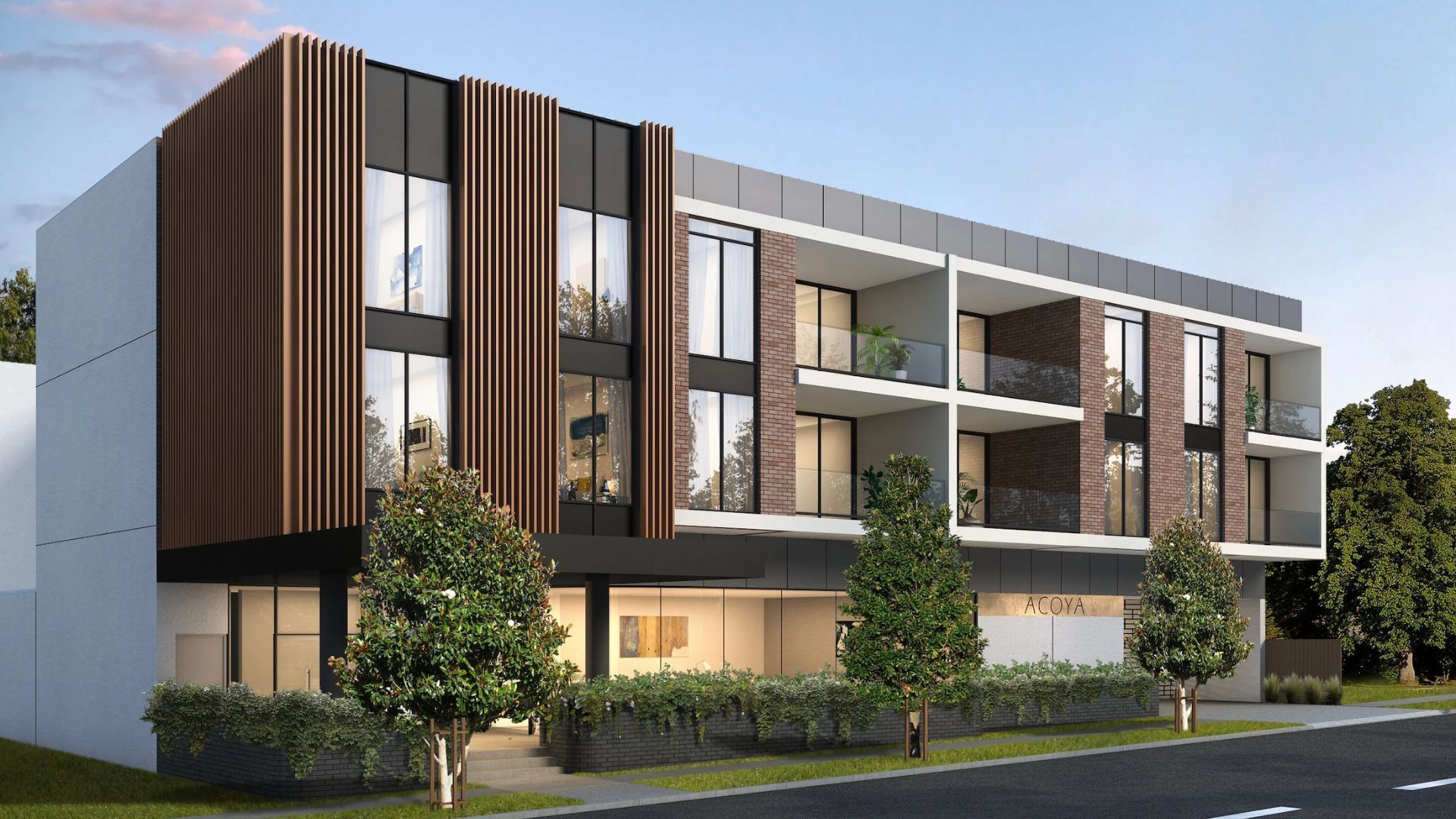 Modern three-story apartment building with wood and white фасade, balconies, and landscaped trees along a street