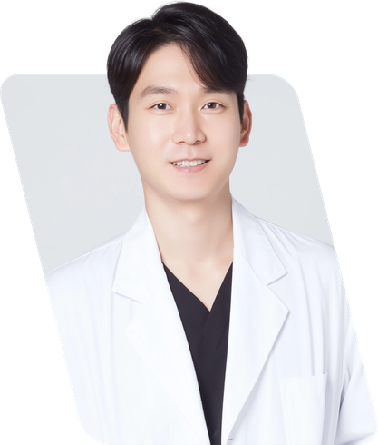Smiling person in a white lab coat over a black shirt against a light gray background