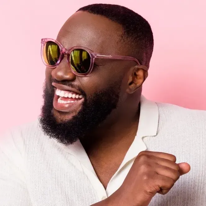 African American man with sunglasses and invisalign aligners