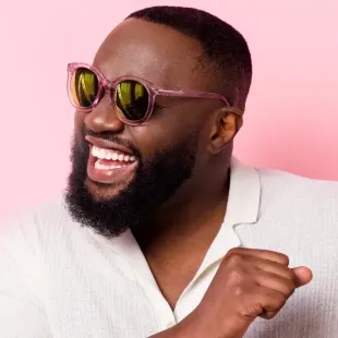 African American man with sunglasses and invisalign aligners