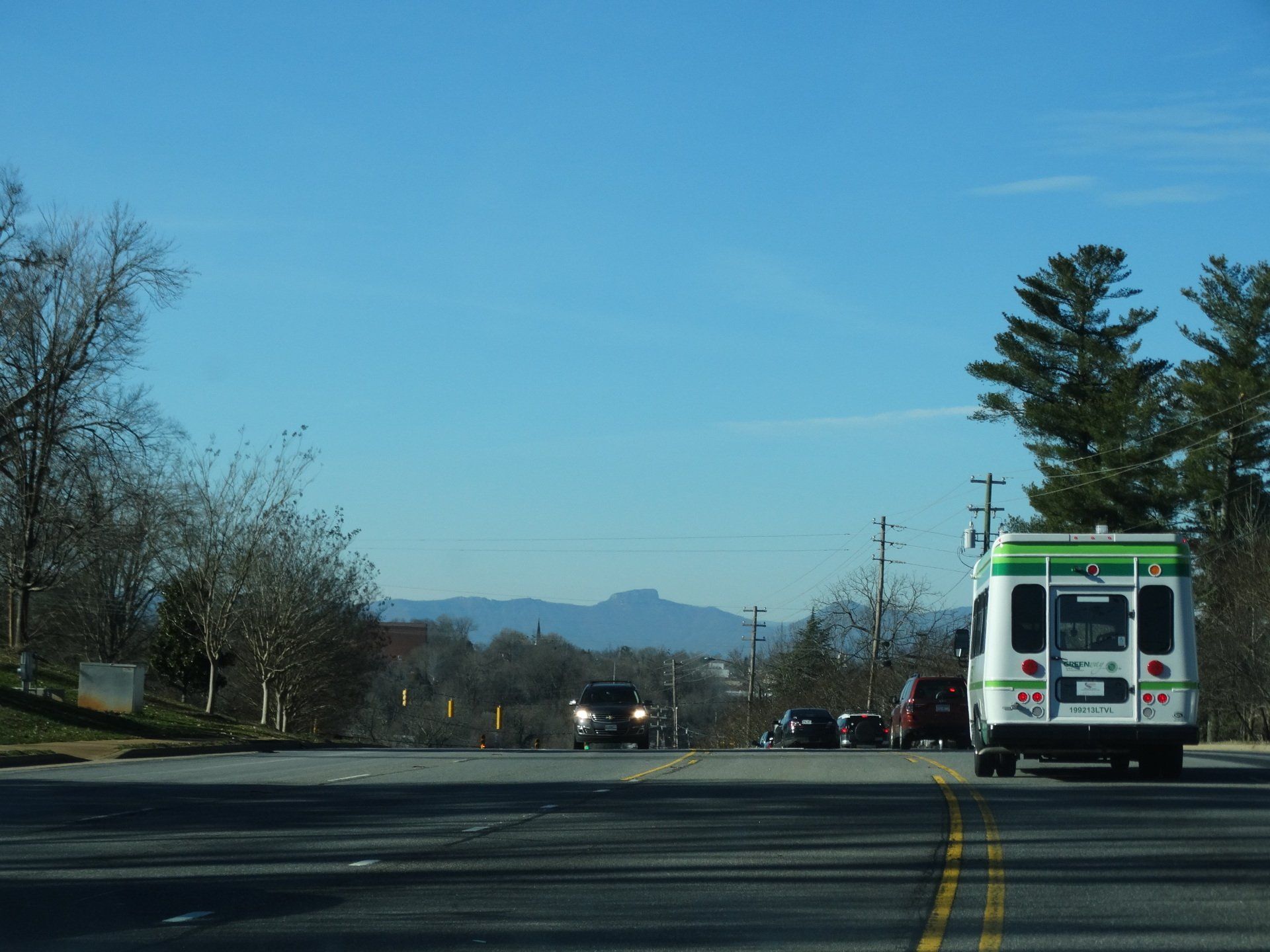 Passenger loading his bicycle on the front of bus