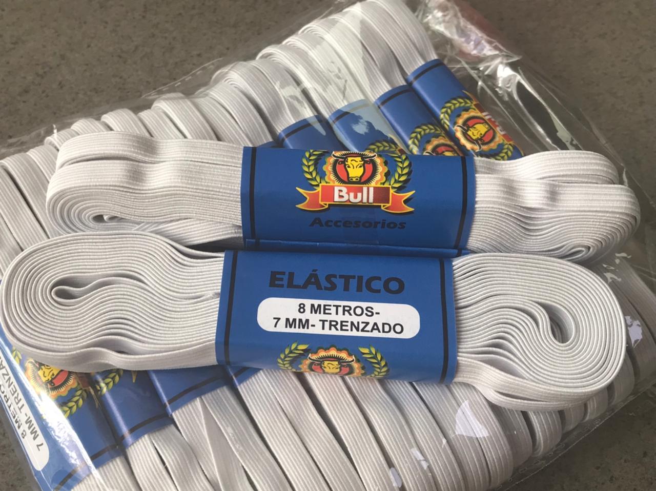 Bundle of white elastic cords with blue-and-red labels on plastic packaging