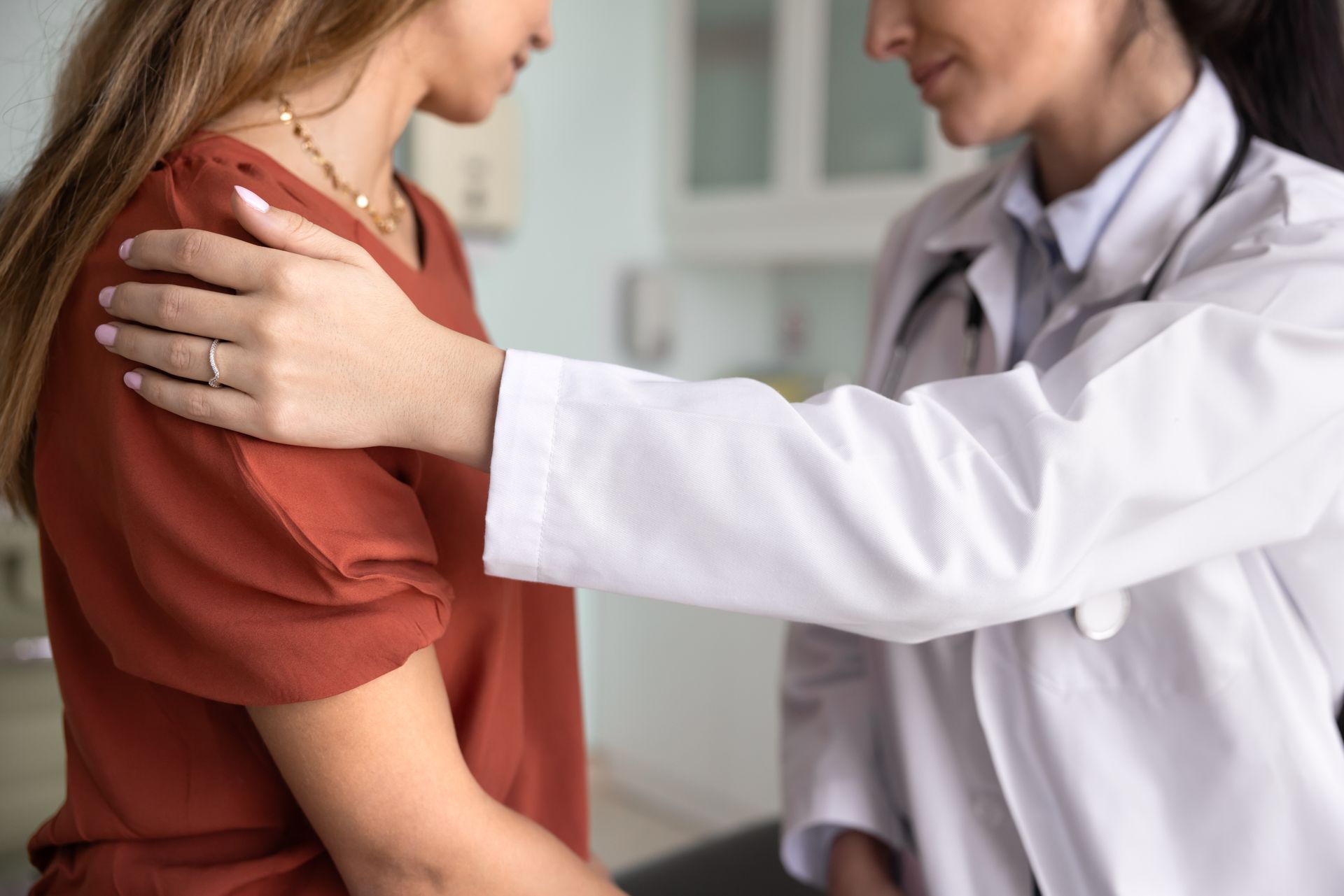 Doctor examining a patient’s shoulder in a clinic