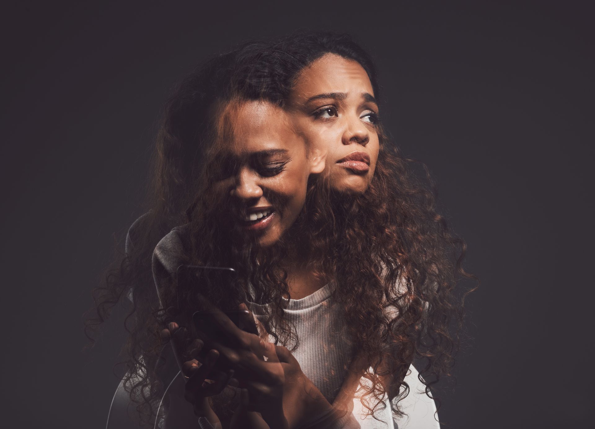 Two overlapping portraits of a smiling woman with curly hair against a dark background