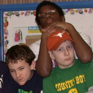 a boy wearing a green shirt that says country boy