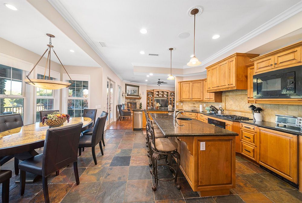 a large kitchen with a large island and a table and chairs