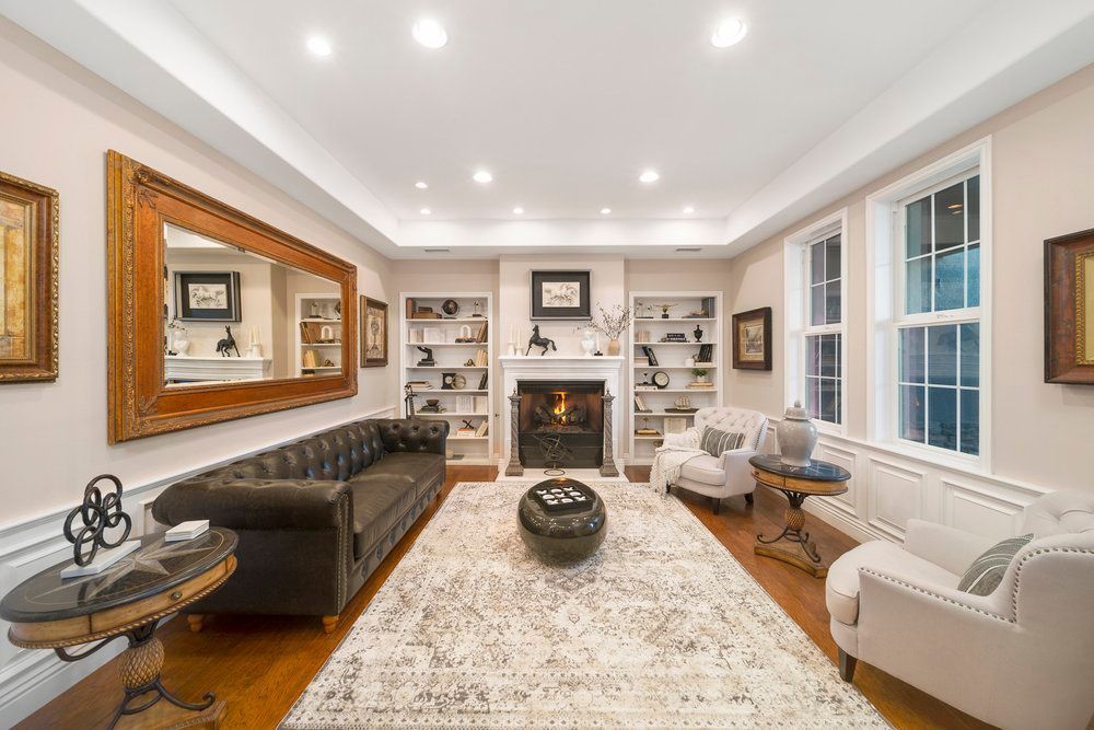a living room with a couch, chairs, and a fireplace