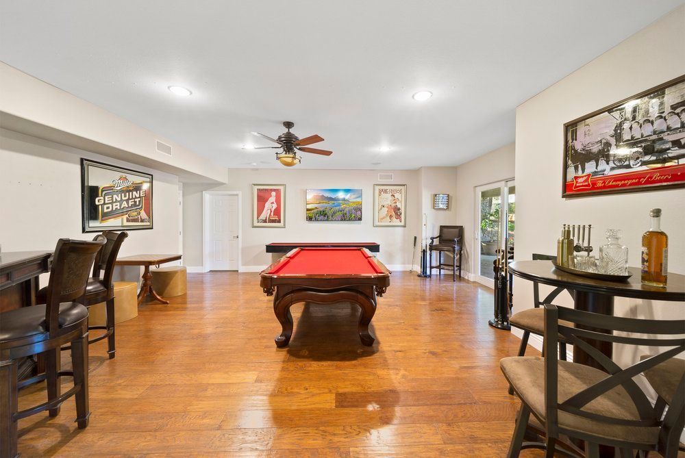 There is a pool table in the middle of the room.