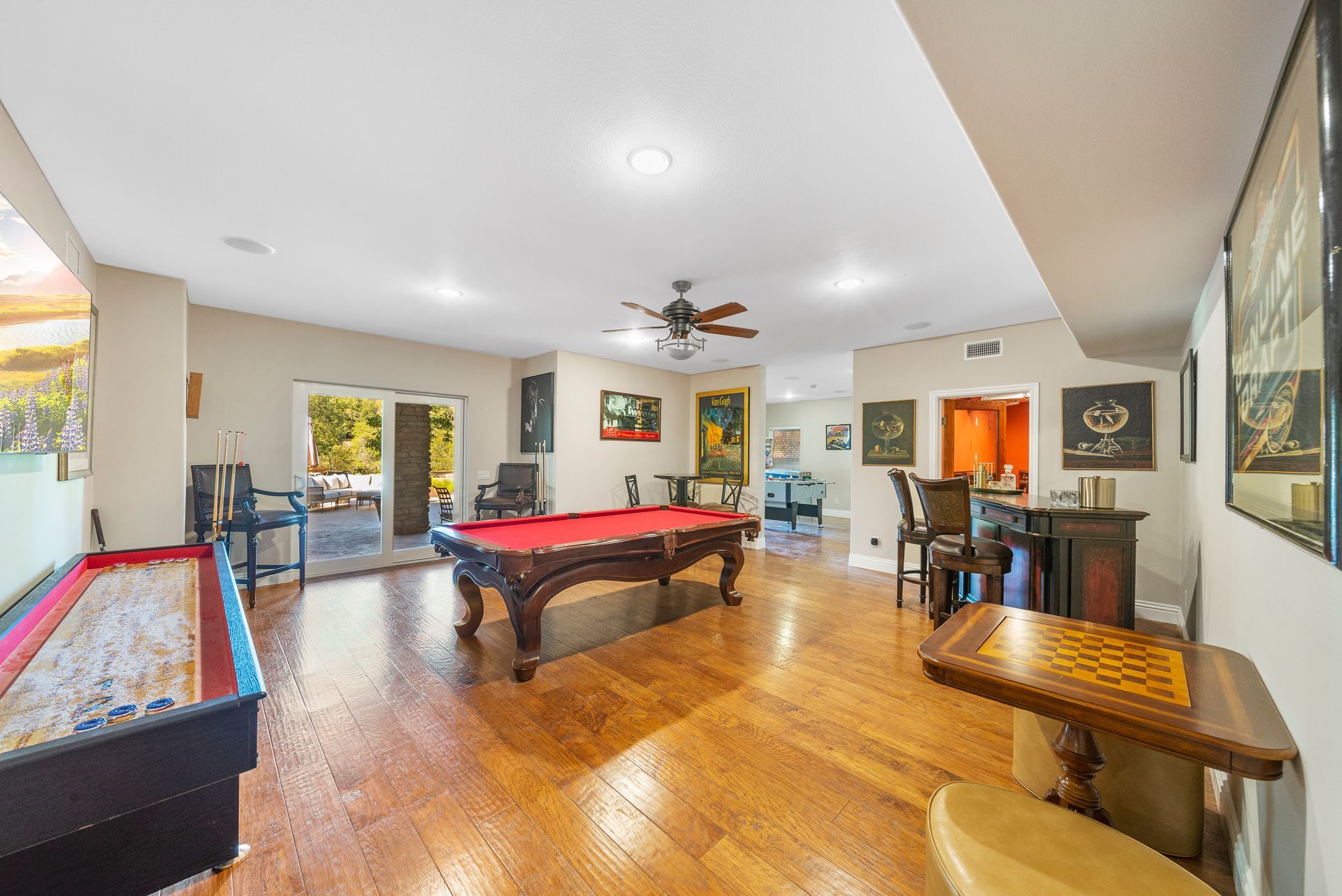 There is a pool table in the middle of the room.