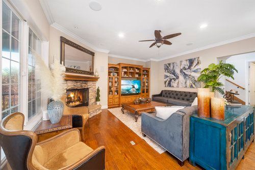 a living room filled with furniture and a fireplace.