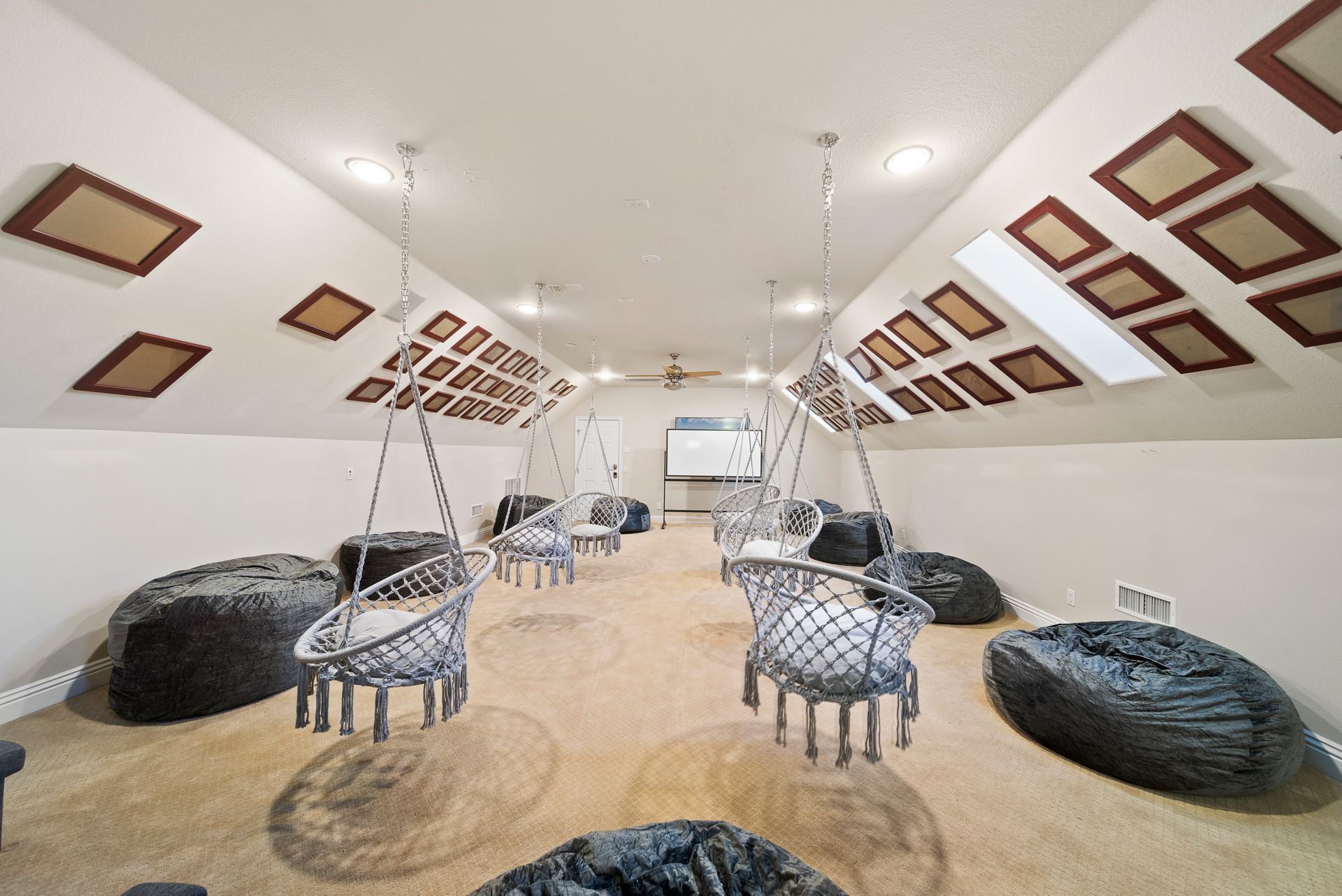 A room with a lot of chairs and bean bag chairs