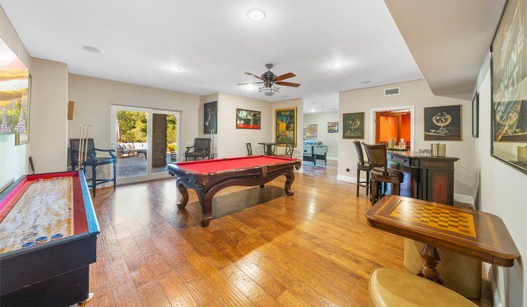 there is a pool table in the middle of the room.