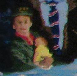 A person in a green jacket holds a small child in a yellow shirt