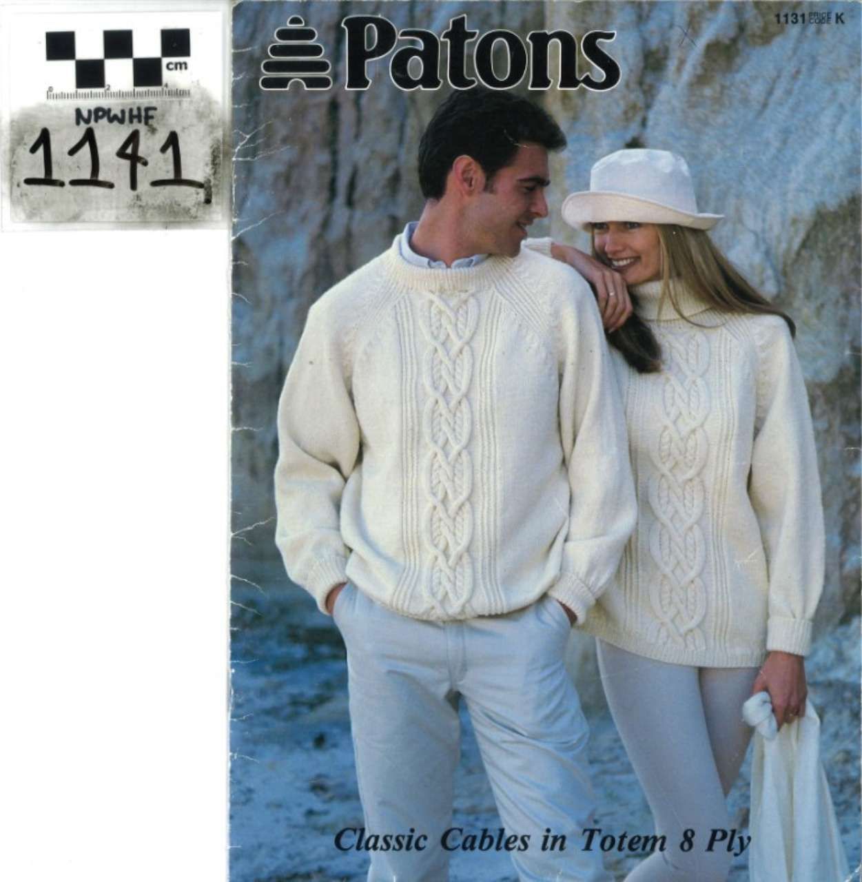 Patons sweater pattern cover with a smiling couple in cream cable-knit sweaters and a baby cap image inset