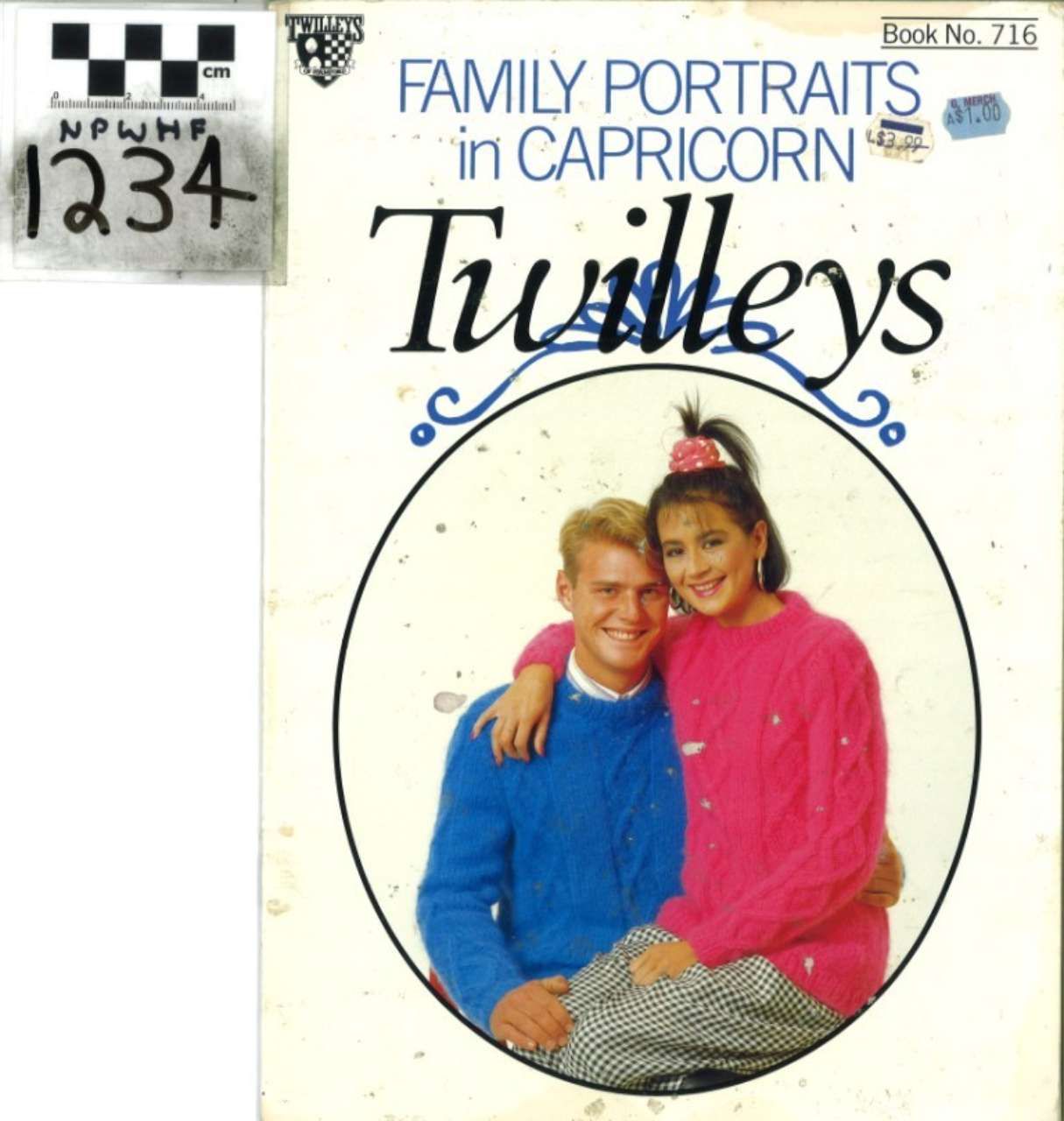 Twilys book cover with a smiling couple, blue and pink sweaters, and a small black-and-white photo in the corner