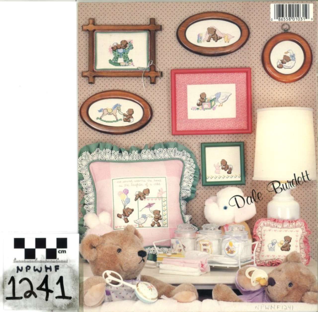 Pastel doll-and-framed-art display on a shelf with teddy bear, lamp, and small figurines