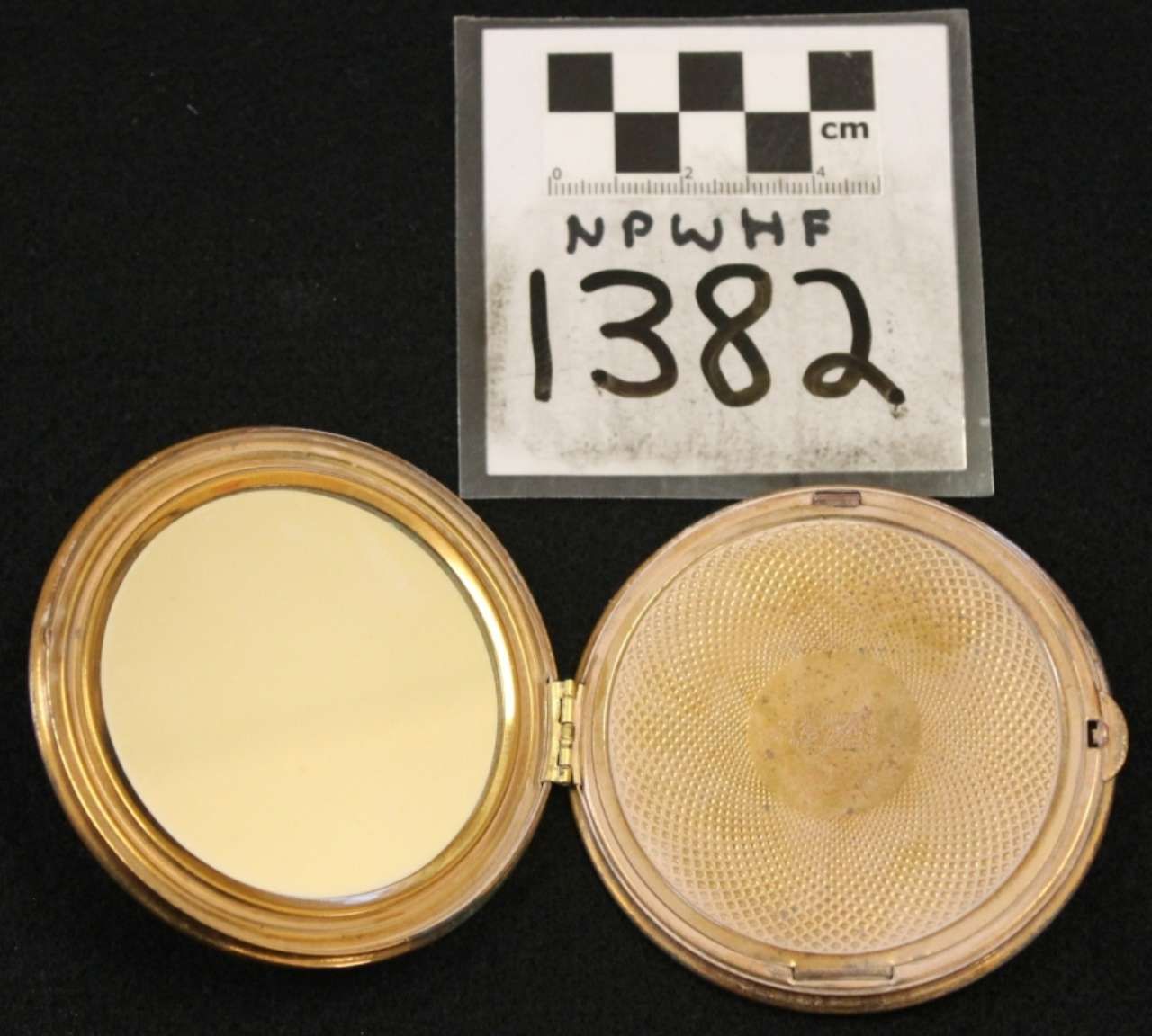 Two round beige woven lids or containers, one open and one closed, with a label and scale card above