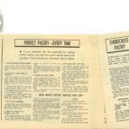 Yellowed newspaper page with a headline and dense columns of text, partially visible on a flat surface