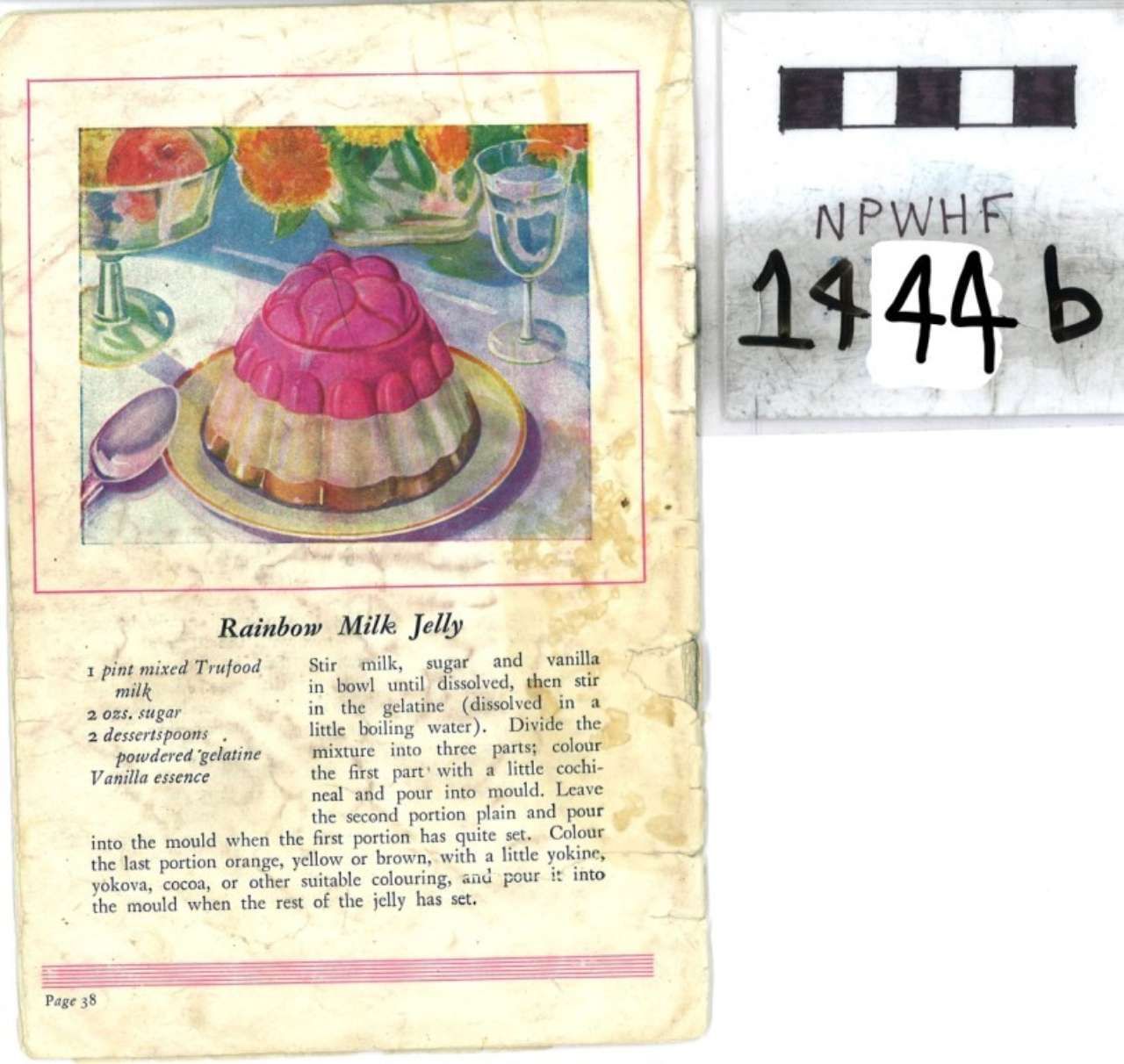 Magazine page with a colorful rainbow jelly dessert illustration and recipe text; handwritten code on the right