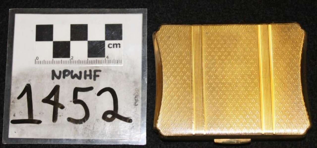 Yellow ridged rectangular metal sample beside a scale card labeled 1452