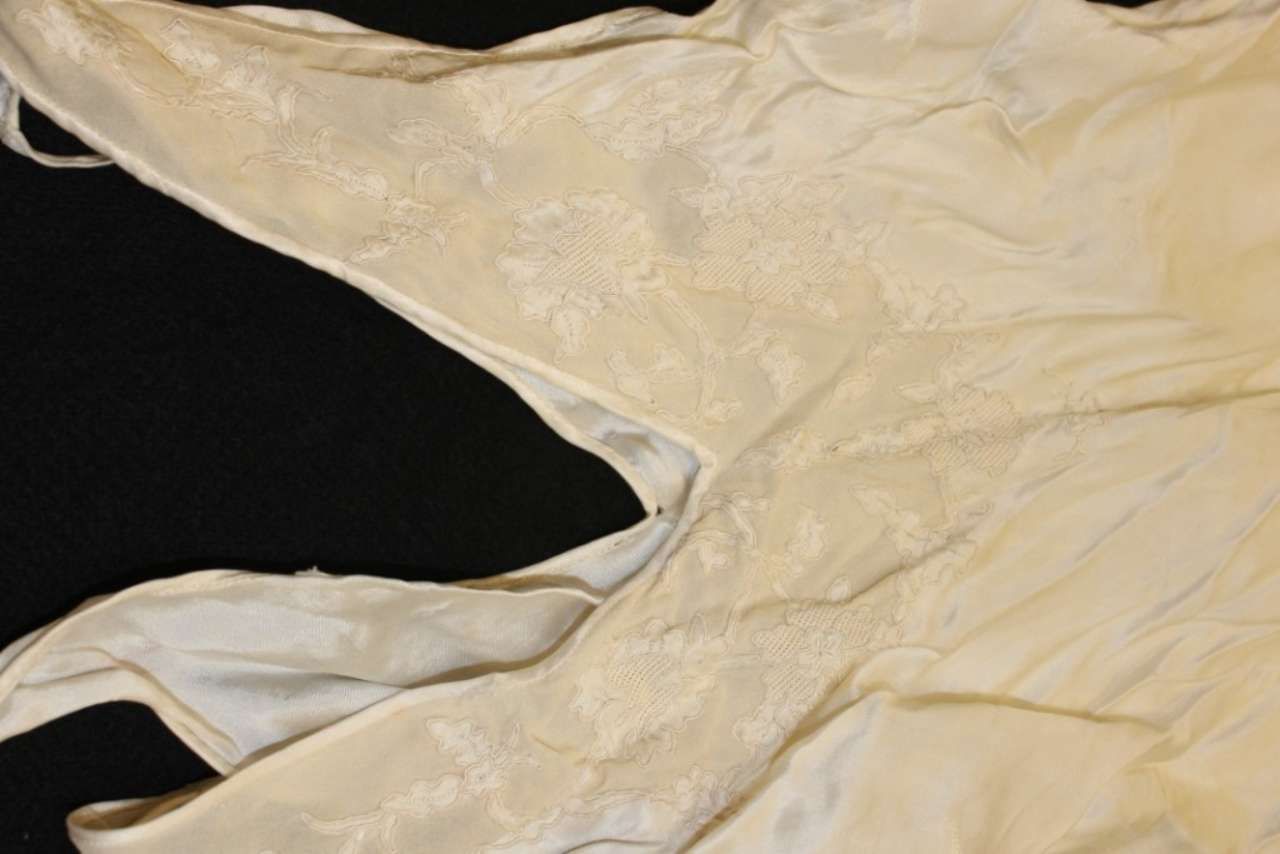 Close-up of beige, wrinkled fabric draped over a black background
