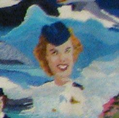 Smiling woman in a blue hat against a snowy mountain backdrop