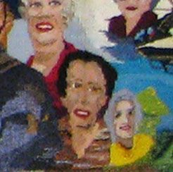 Colorful painted mural of several faces, including a central face with glasses and a red mouth