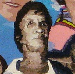 Portrait of a man in a painted mural, shown against a colorful background