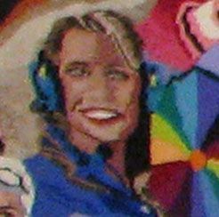 Smiling person wearing blue headphones in front of a colorful geometric background