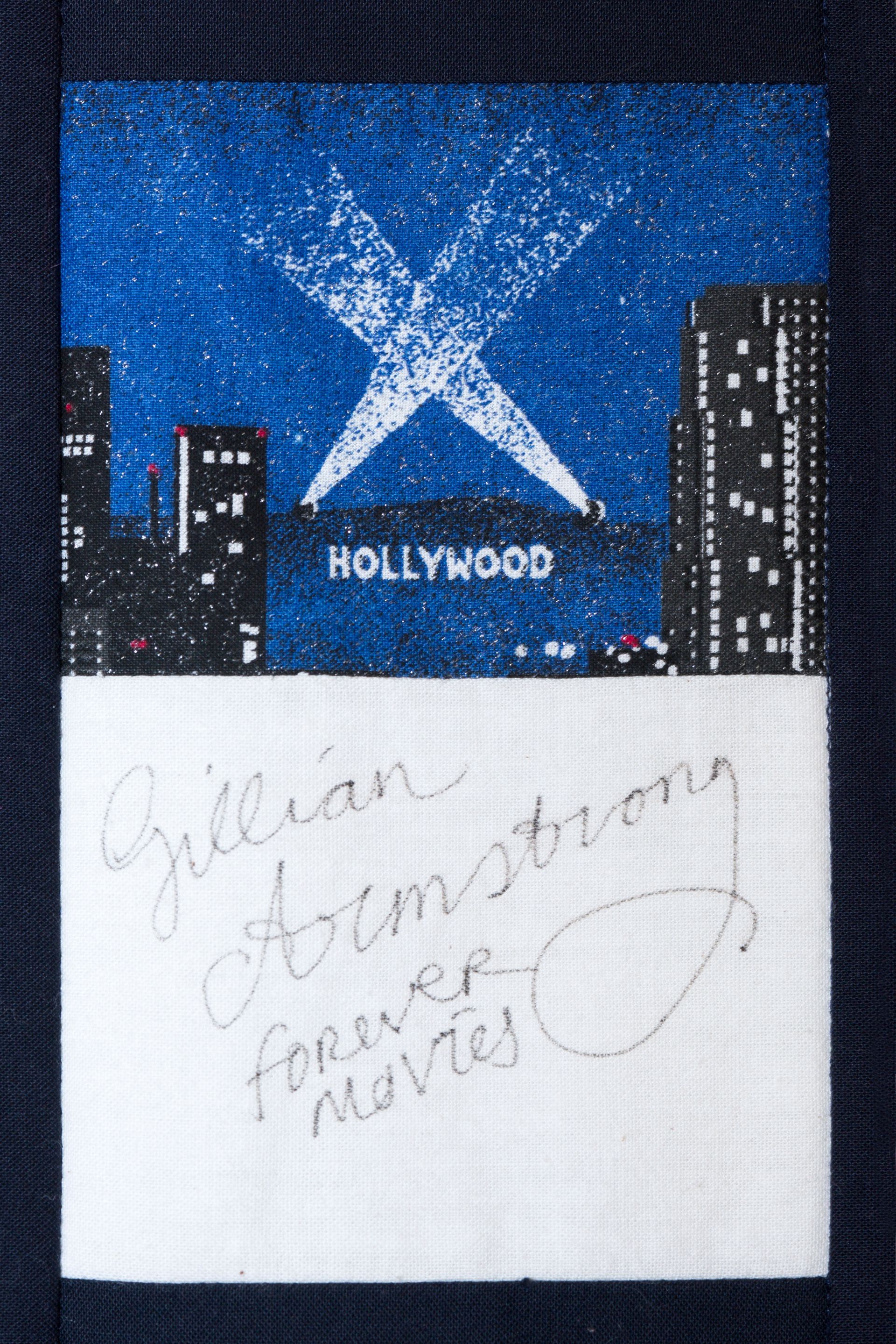 Hollywood sign collage with a blue sky, black city buildings, and a white note beneath it.