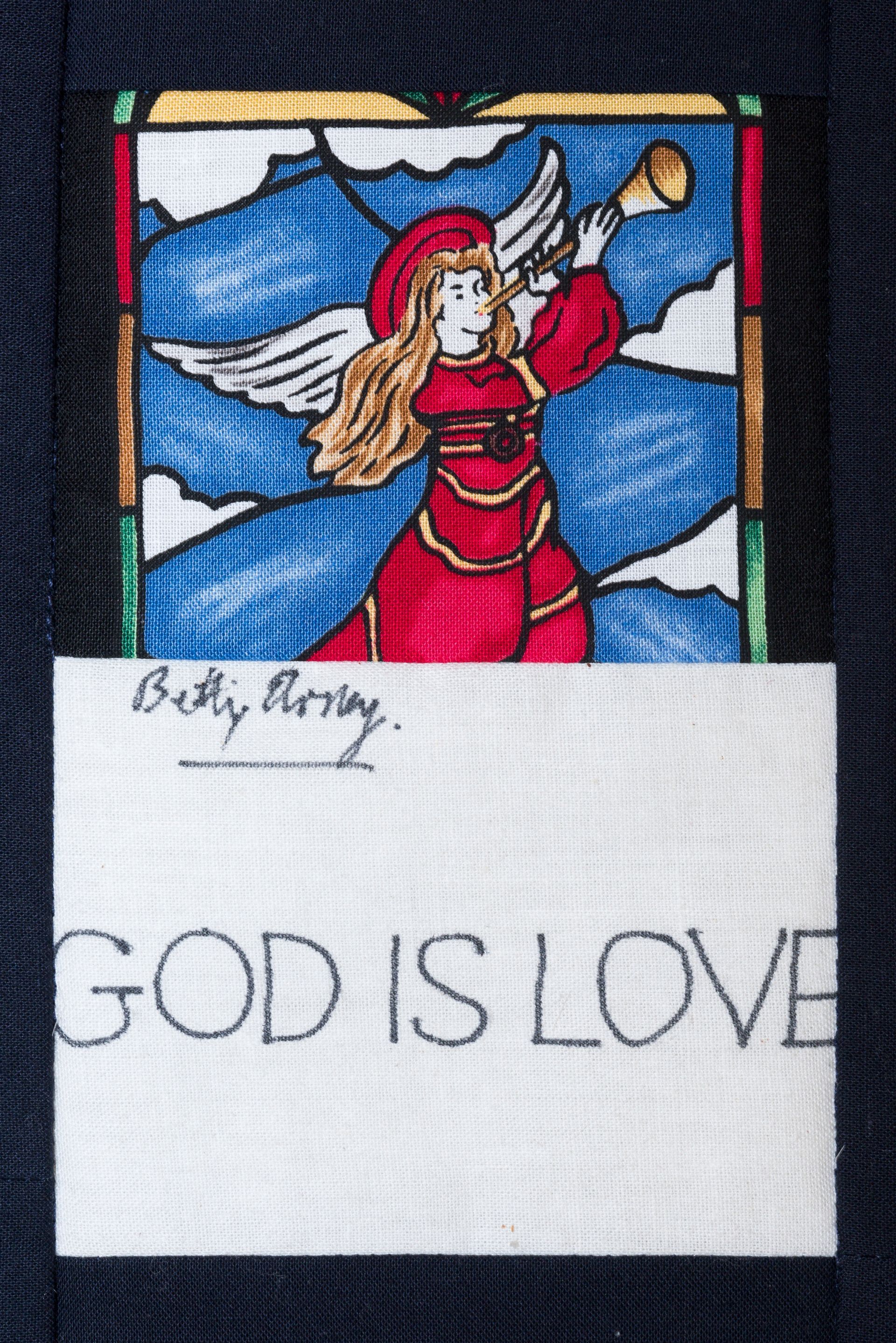 Stained-glass angel with red dress above handwritten note reading “GOD IS LOVE”