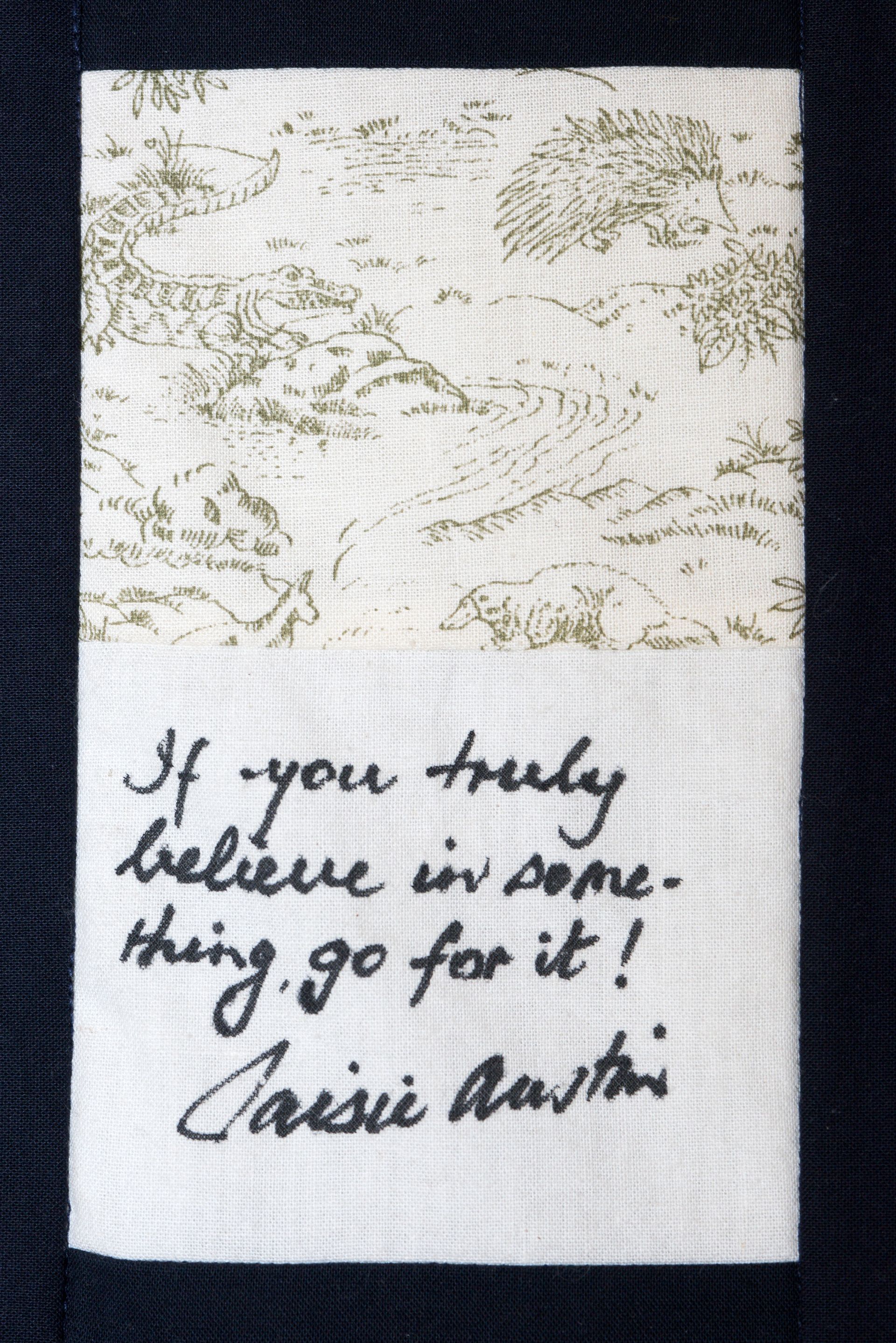 White cloth with cursive quote: “If you truly believe in something, go for it!” — Cassie Marah.