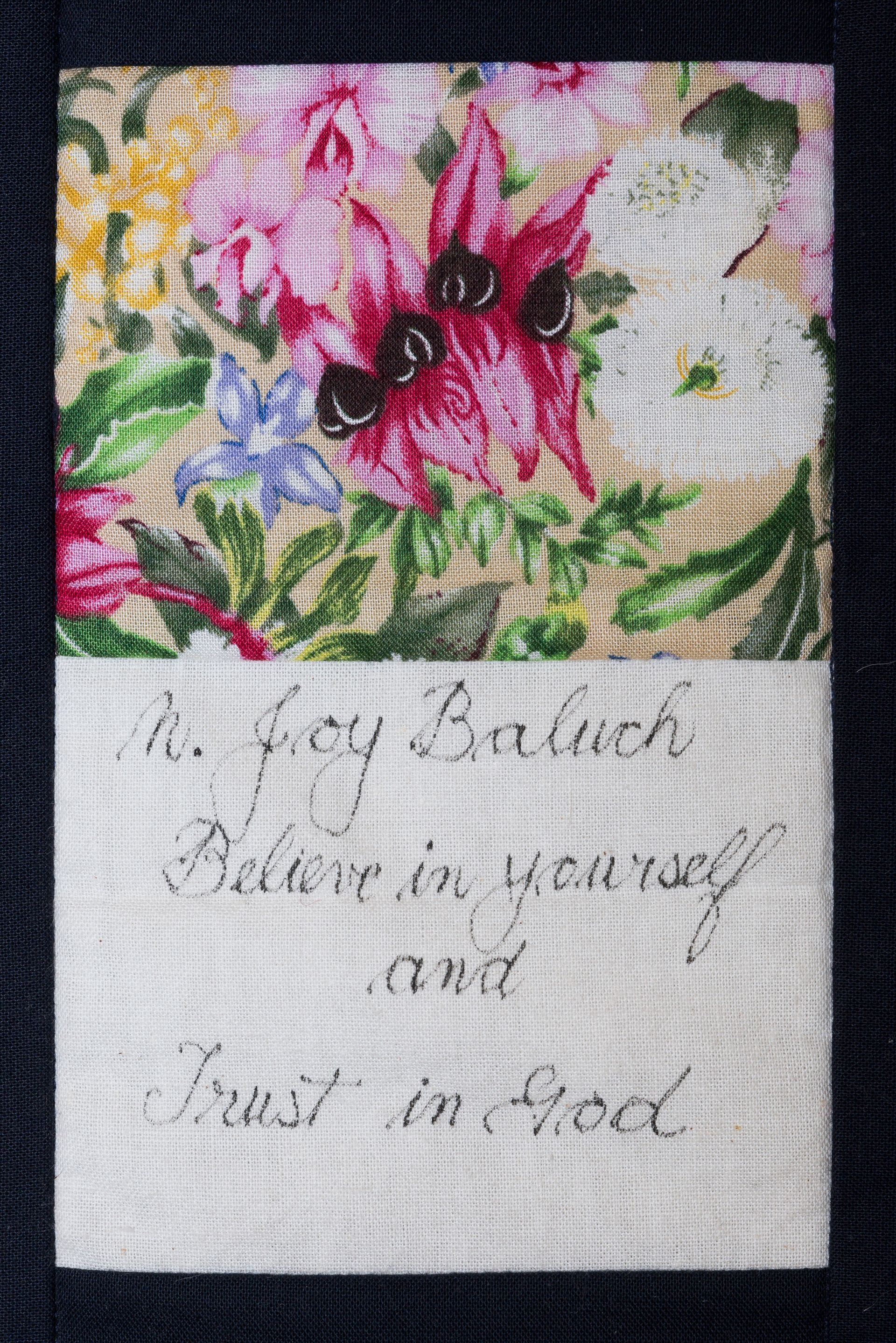Hand-stitched floral sampler with pink flowers and a handwritten note below.