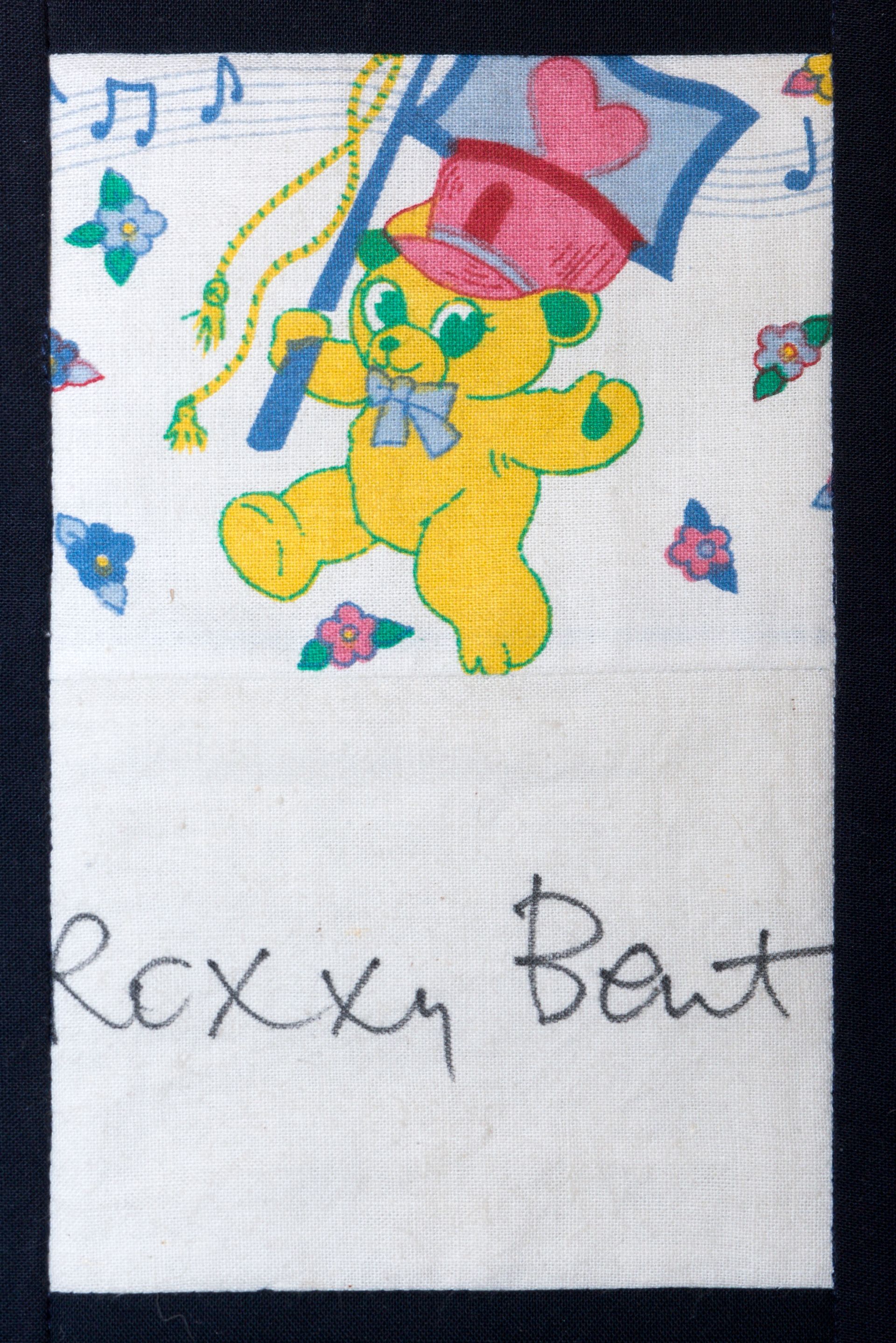 Colorful drawing of a bear wearing a hat with musical notes and the words “Bexy Boat” below