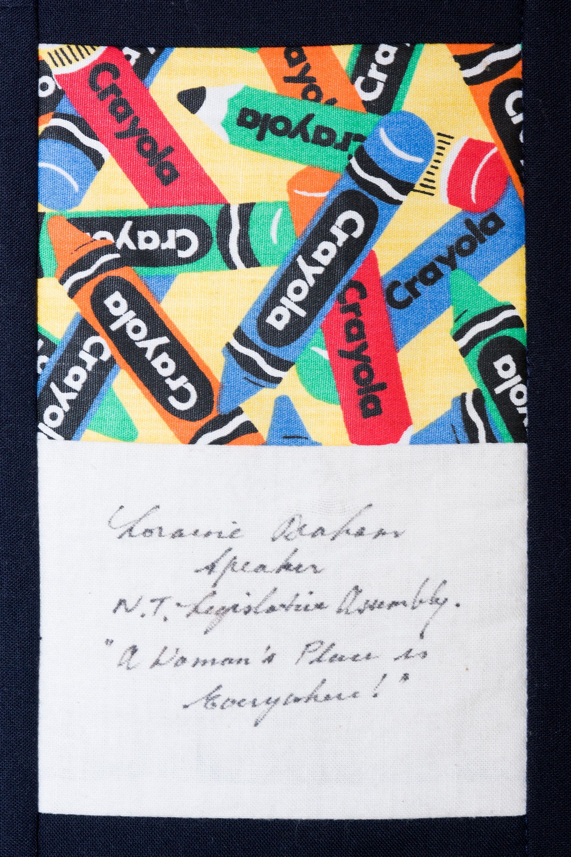 Colorful abstract crayon pattern with a small white note bearing handwritten text