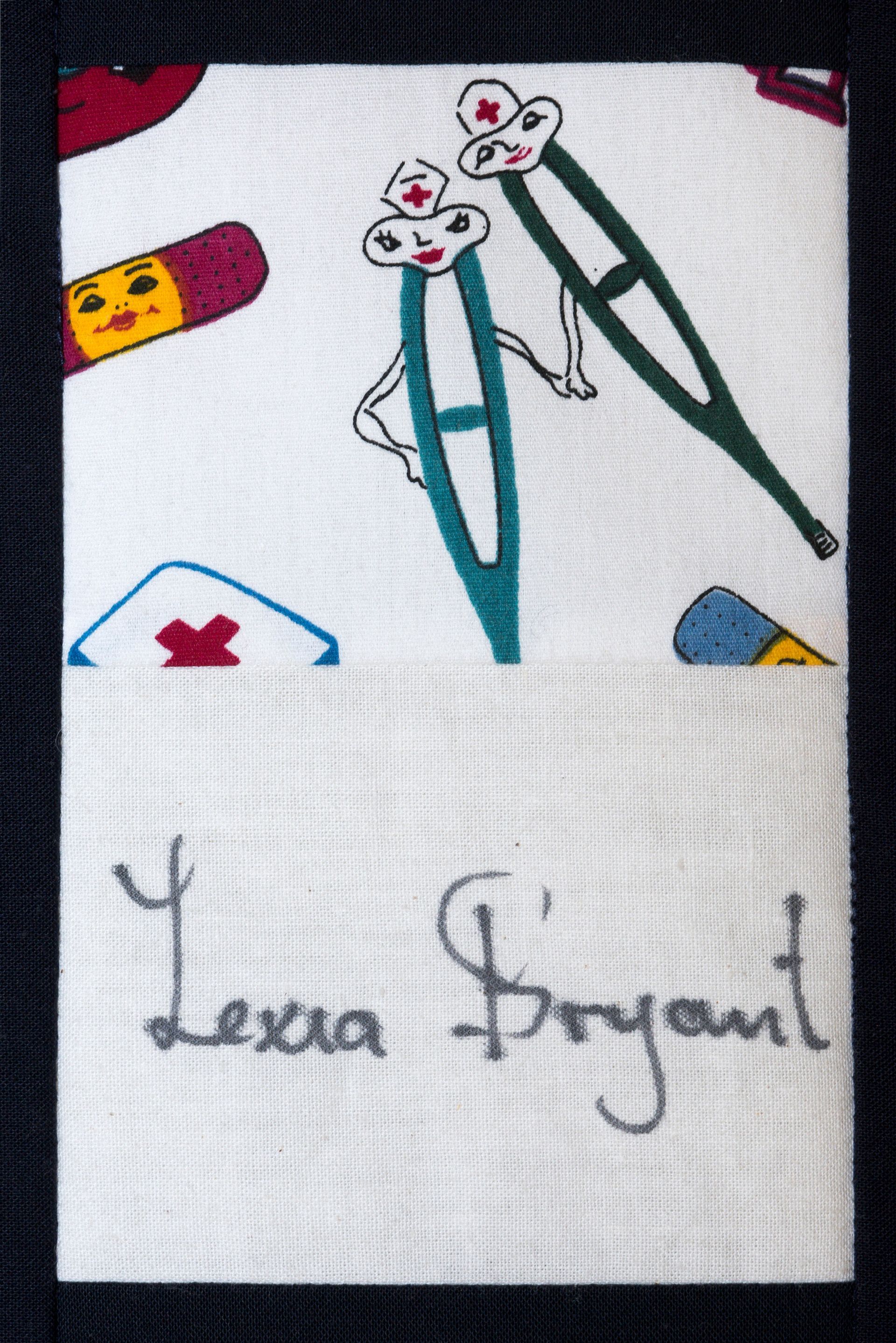 Handwritten signature below two cartoon pens and playful doodles on white fabric