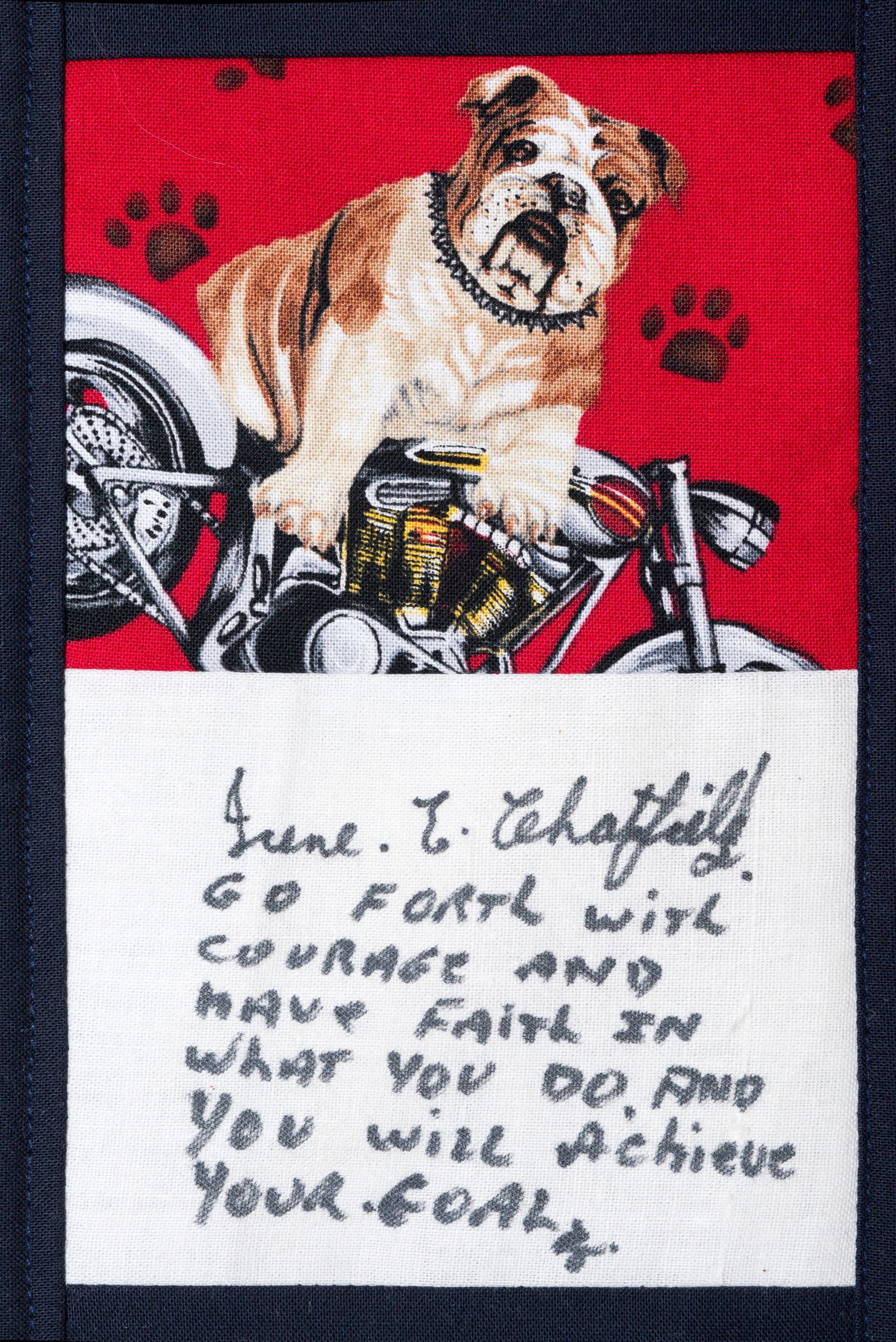 Bulldog on a motorcycle with graffiti-style red background and handwritten motivational quote below.