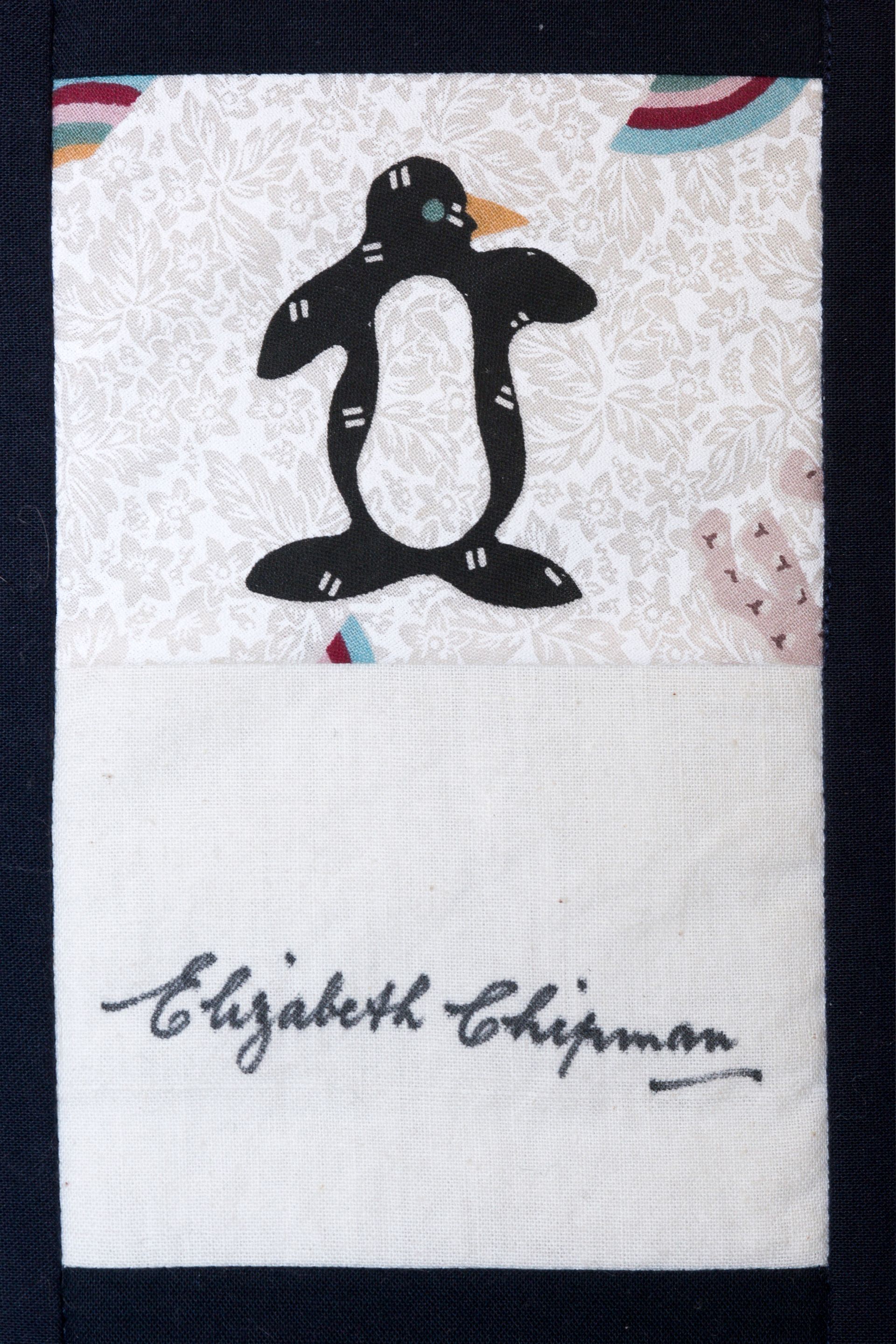 Black-and-white penguin graphic on a white fabric background with the name “Elizabeth Chapman” below.