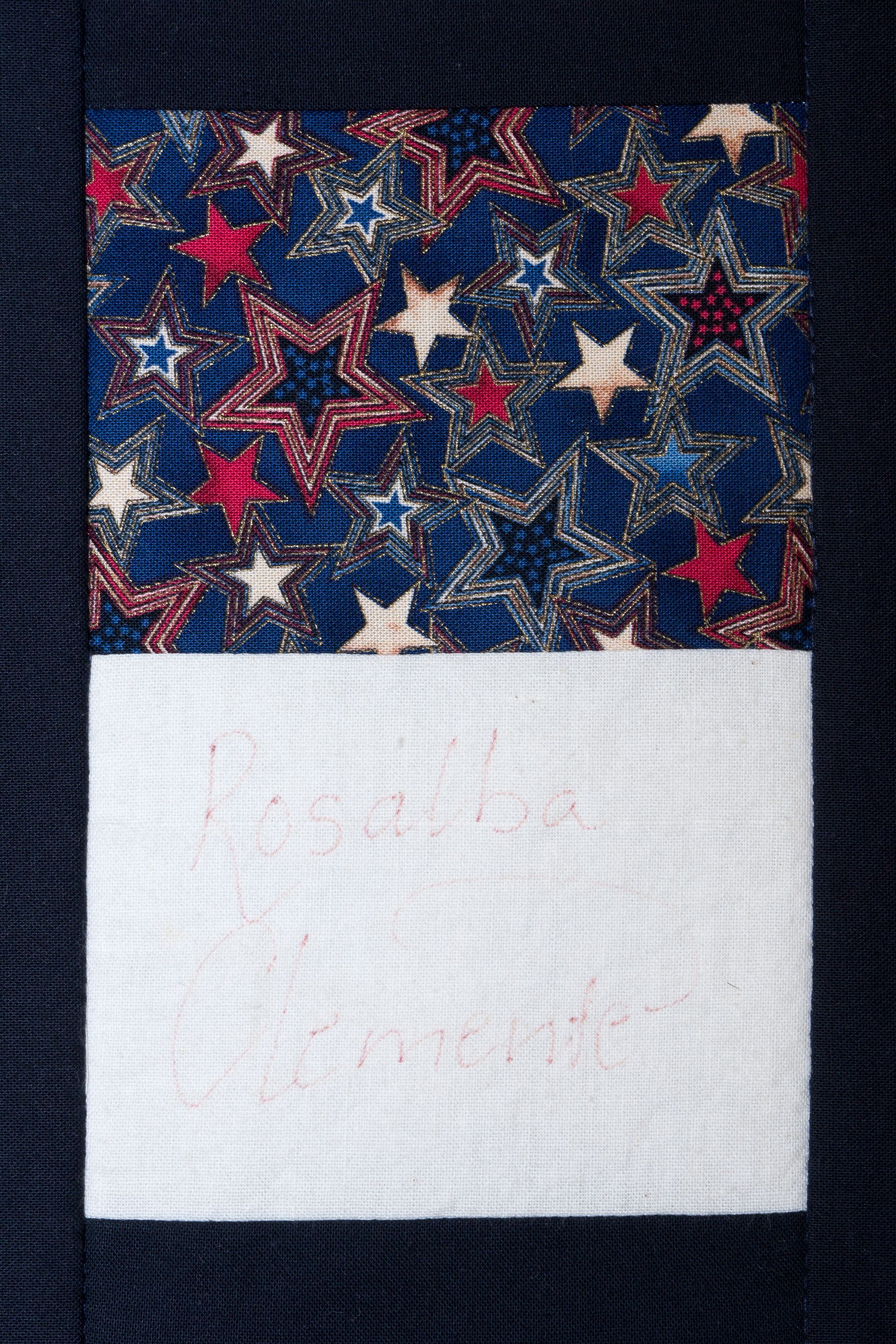 Star-patterned blue fabric above a blank white rectangle on a dark background