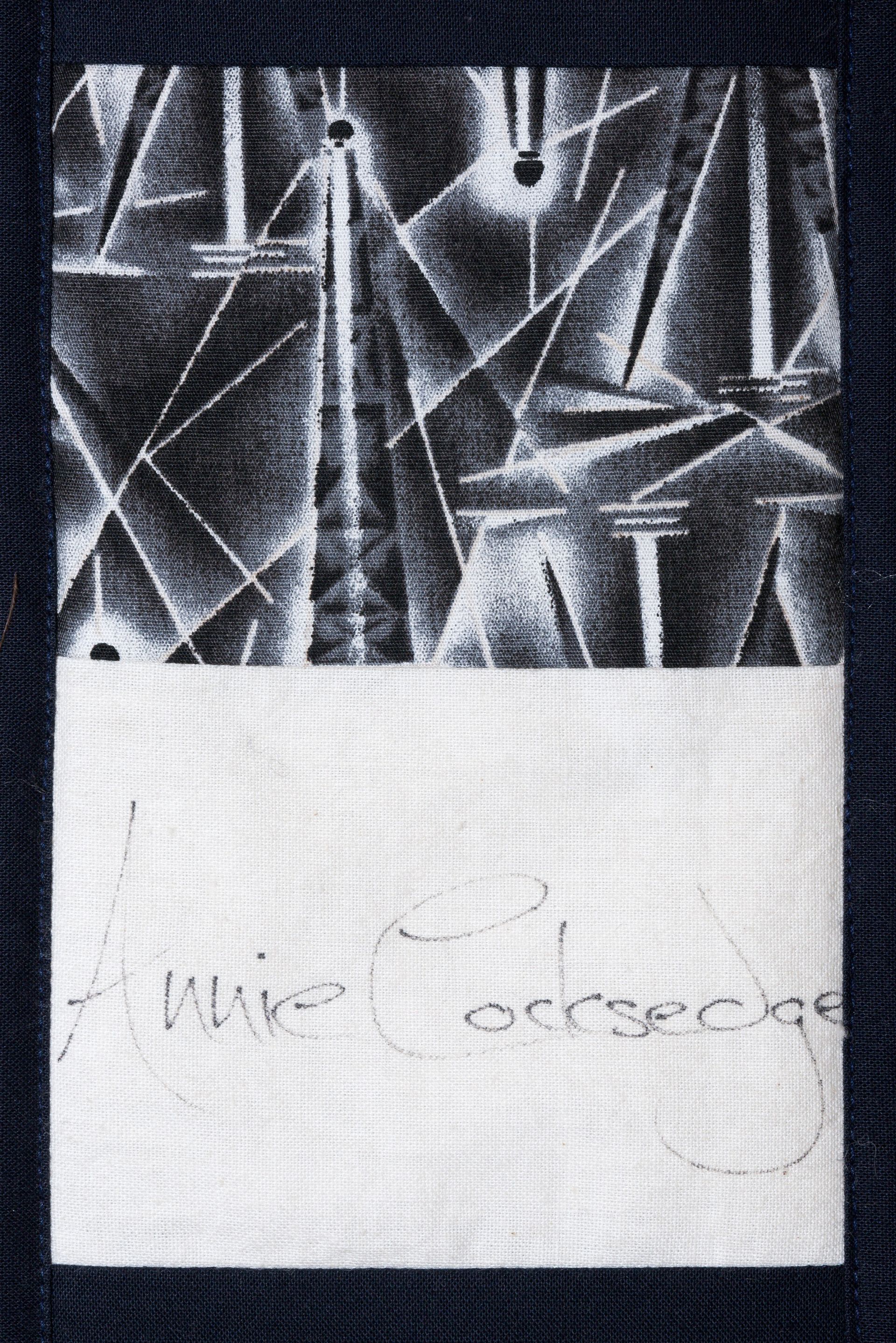 Black-and-white abstract pattern above a faint handwritten note on white paper